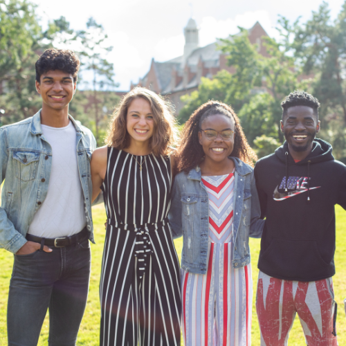 Four students smiling at the camera