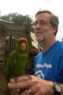 man holding a parrot on his fingers