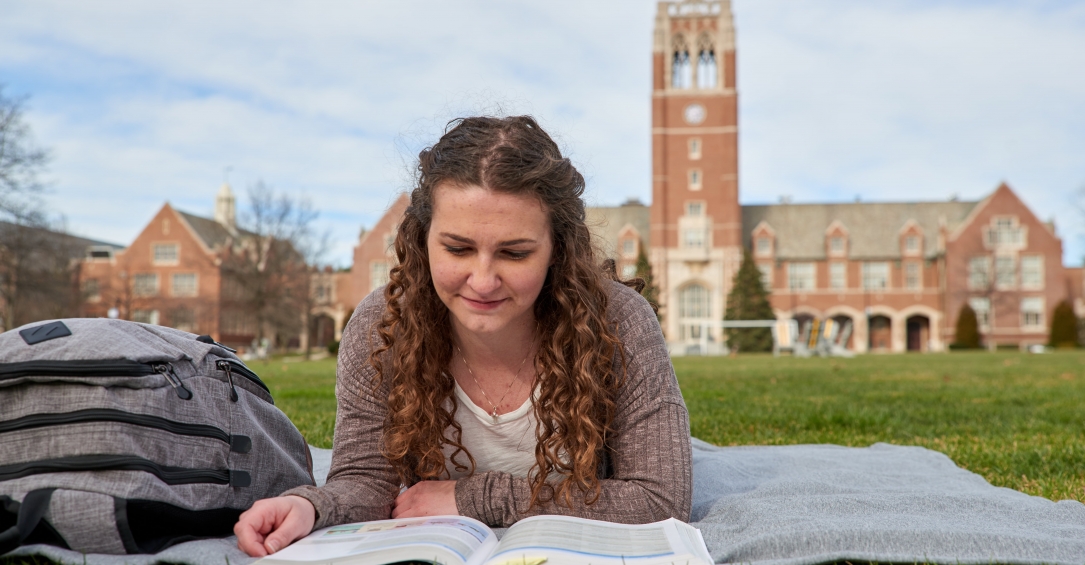 Student Reading on Quad