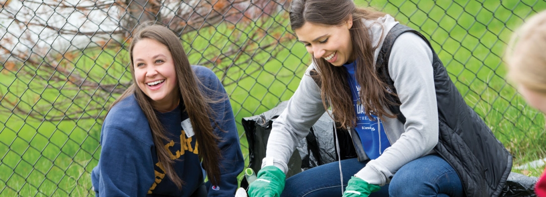 two women students smiling outside