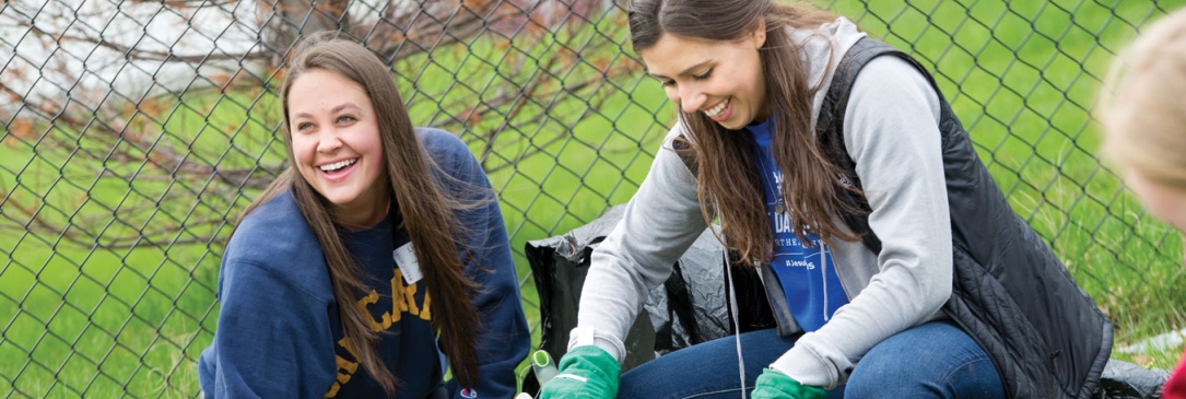 two women students smiling outside